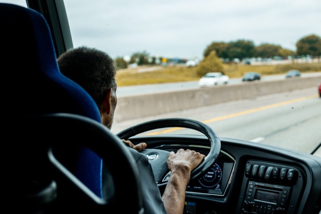 Corporate Shuttle Service: What the Setup Actually Involves 5 Charter bus driving on a New Jersey highway during a corporate shuttle trip